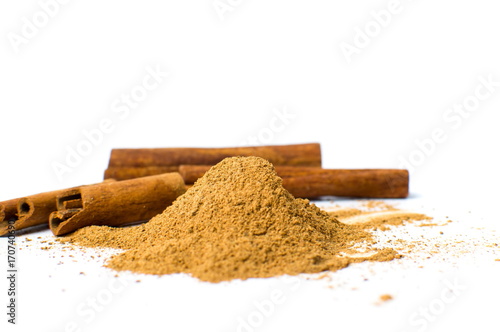 Cinnamon powder and sticks isolated