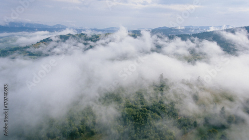 aerial view of misty mountains covered beautiful forest