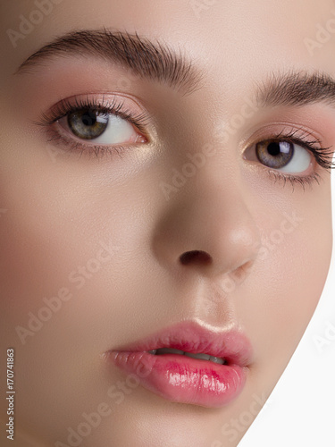 Macro sensual portrait of the woman with a day make-up and pure leather. Sensual full lips and equal eyebrows. Care of skin, Spa, cosmetology, correction of eyebrows photo