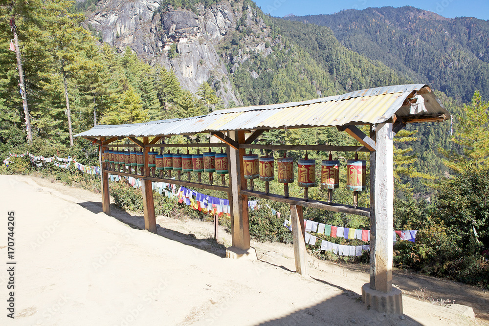 Prayer wheels along the footpath to the Tiger's Nest, Paro, Bhutan Prayer wheels along the footpath to the Tiger's Nest, Paro, Bhutan