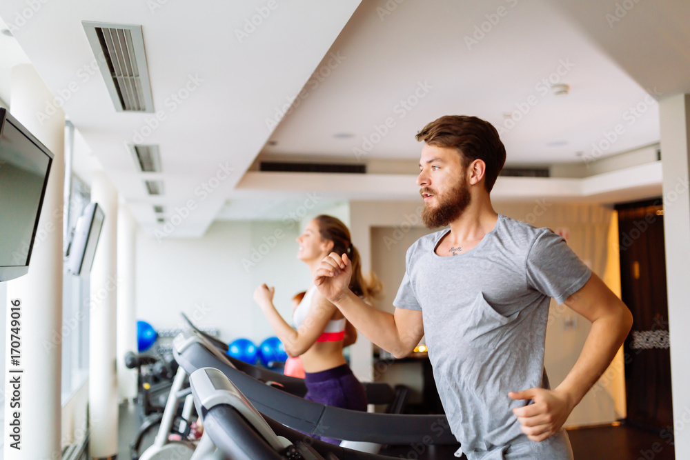 People running on treadmill in gym People running on treadmill in gym