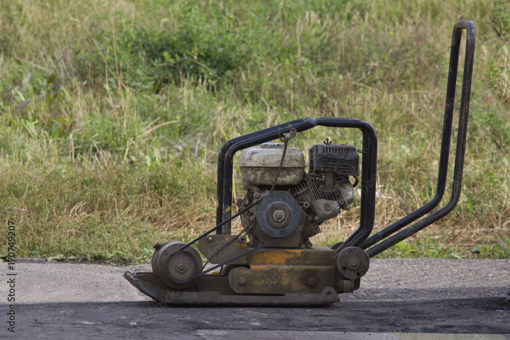 Manual ramming machine for road construction - telephoto Manual ramming machine for road construction - telephoto