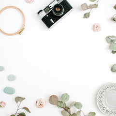 Flat lay border frame with retro camera, eucalyptus branches, plate on white background. Top view artist background with space for text.
