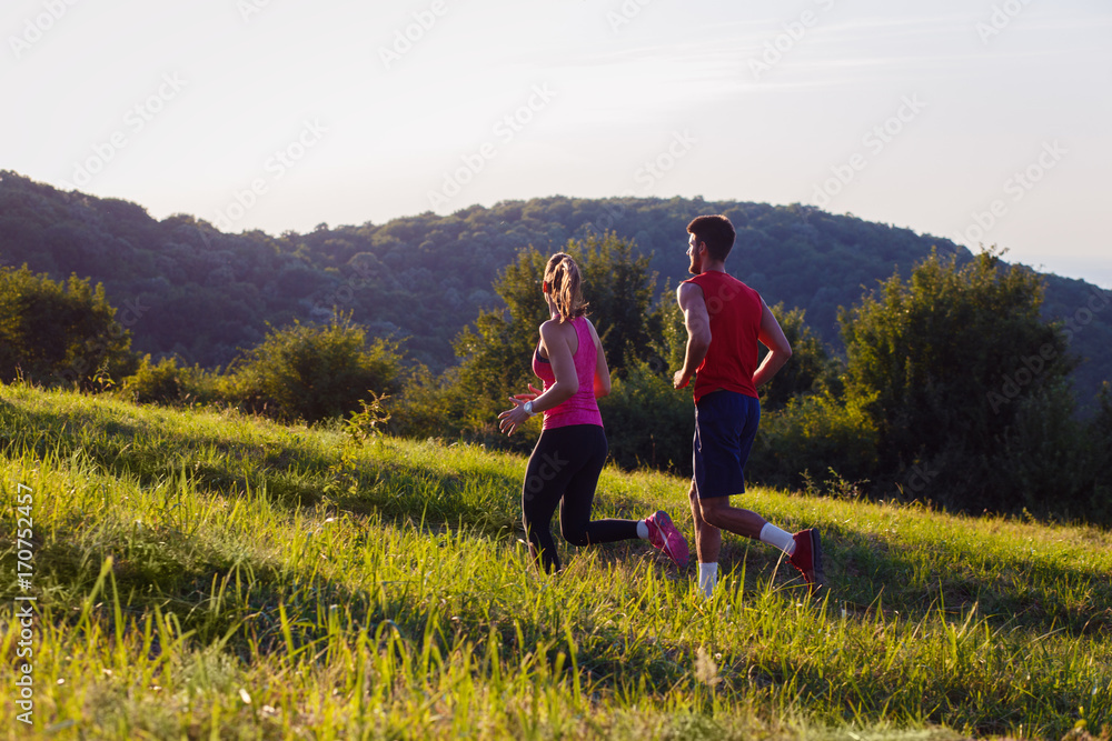 Young couple running in nature on sunset and having fun. Young couple running in nature on sunset and having fun.