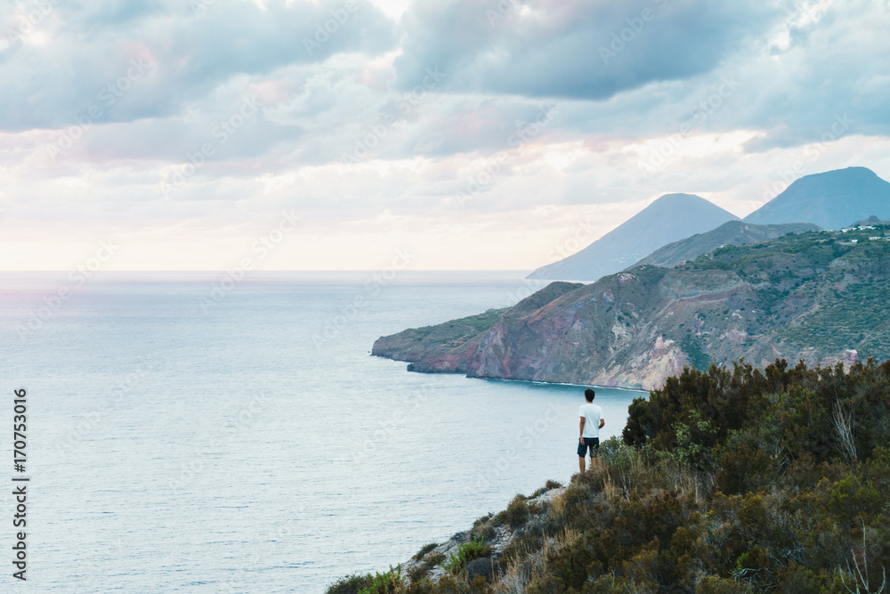 Man standing on picturesque landscape Man standing on picturesque landscape
