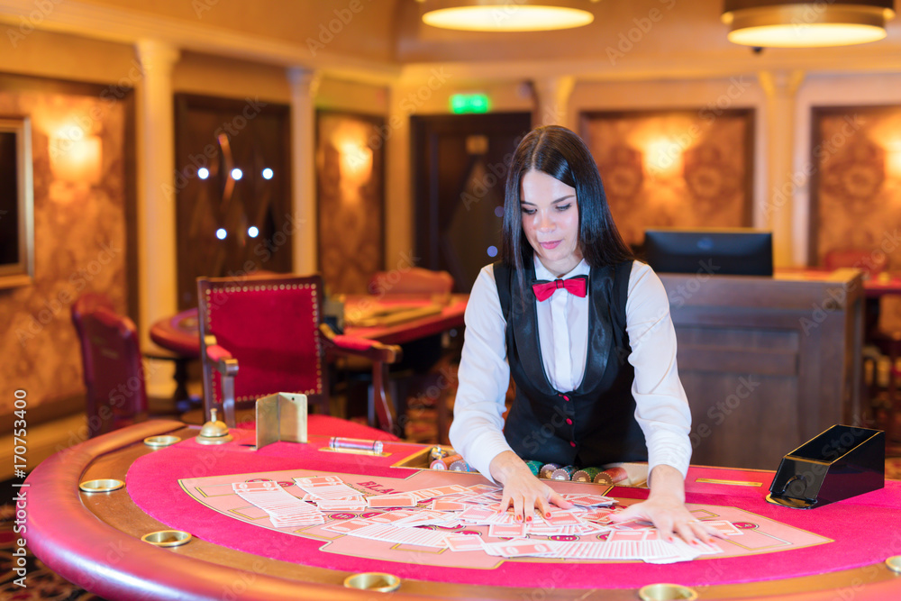 Cute lady casino dealer at poker table. Cute lady casino dealer at poker table.