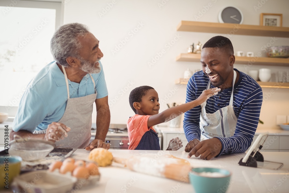 Multi-generation family with flour on the nose standing in the Multi-generation family with flour on the nose standing in the