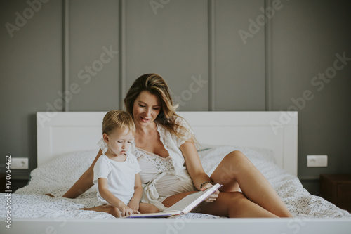 Young mother reading book t...