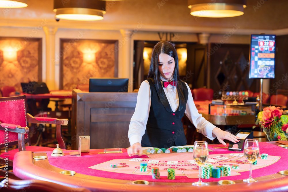 Cute lady casino dealer at poker table. Cute lady casino dealer at poker table.