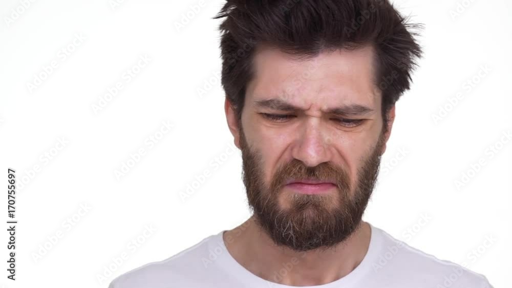 Caucasian bearded man shrivels smells something stinky
