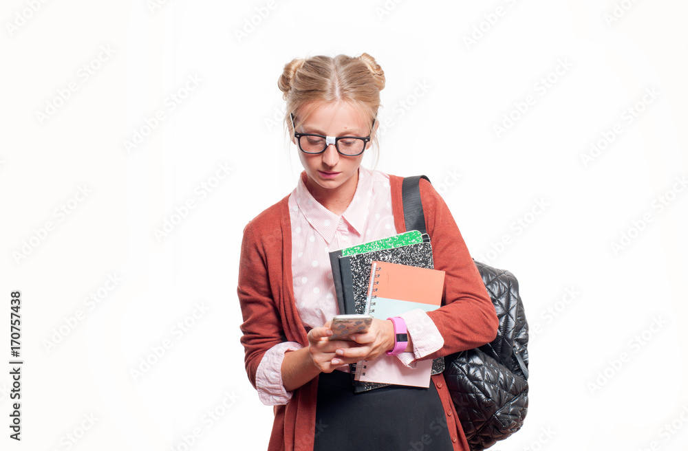 Young student girl holding books and using smart phone.. Back to school Young student girl holding books and using smart phone.. Back to school