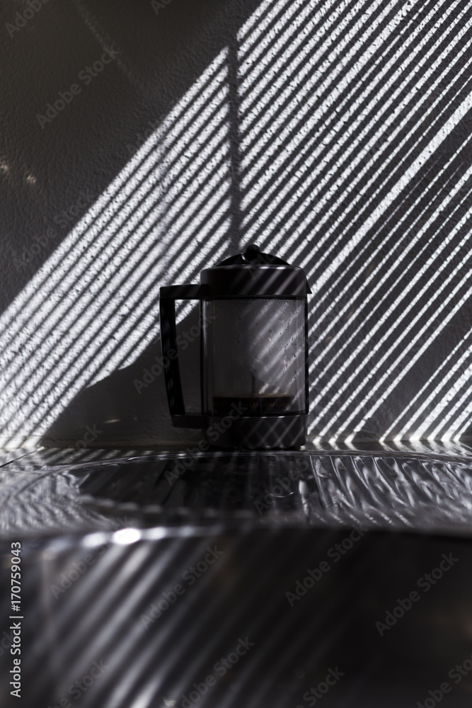 coffee machine in the kitchen. Beautiful light from the window blind. stripes