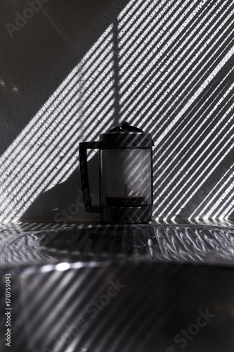 coffee machine in the kitchen. Beautiful light from the window blind. stripes © Eva