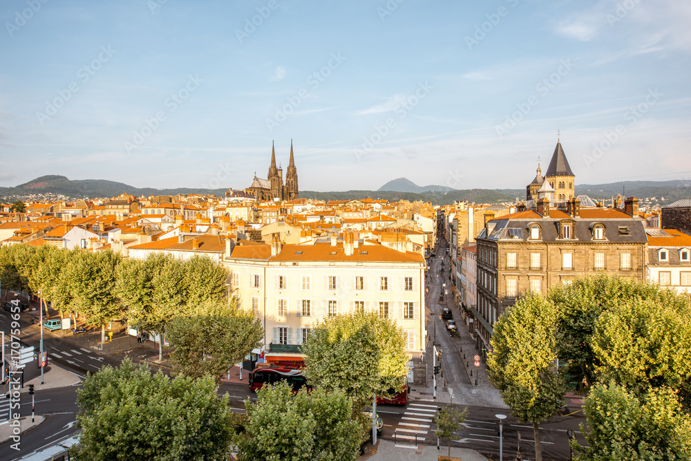 Morning aerial cityscape view on Clermont-Ferrand city with beautiful cathedral and mountains on the background in central France