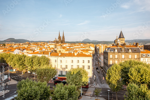 Morning aerial cityscape view on Clermont-Ferrand city with beautiful cathedral and mountains on the background in central France