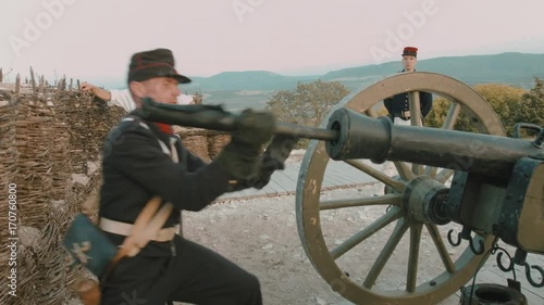 French soldier cleans gun barrel before shot