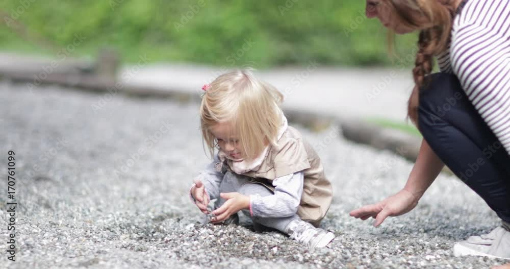 Mother and daughter in playground playing with sand Mother and daughter in playground playing with sand