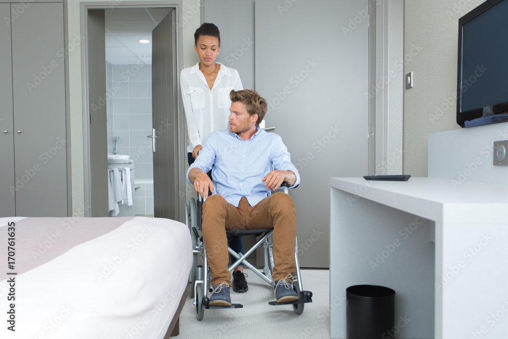 Obraz premium businessman in a wheelchair with her colleague