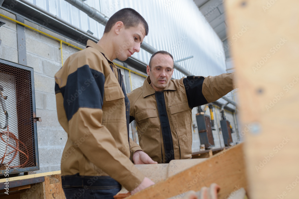 builder with young apprentice builder with young apprentice