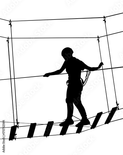 boy in adventure park rope ladder. Silhouette Adventure. Extreme sportsman took down with rope. Sport weekend action in adventure park rope ladder.