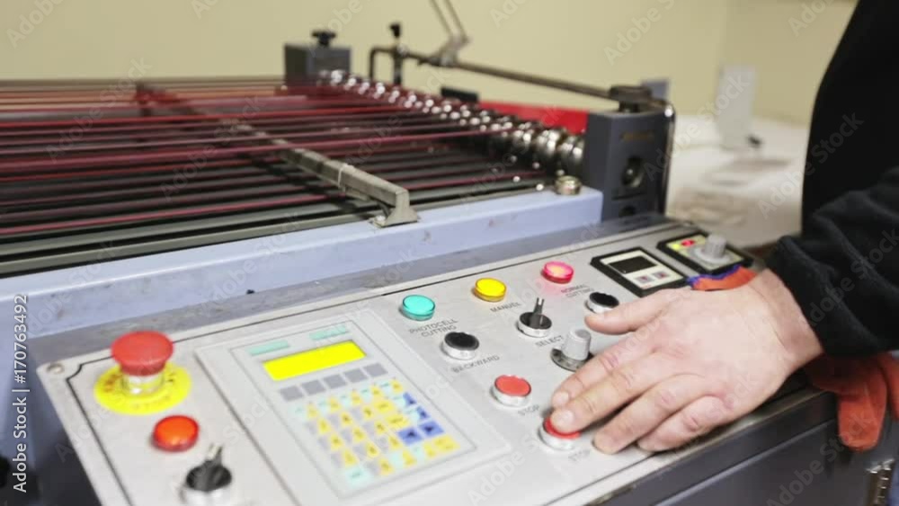Automated line for making packaging production. Interior view of system control panel in control room. Industry equipment. Worker push the button and accelerate conveyor. Only hands close up Automated line for making packaging production. Interior view of system control panel in control room. Industry equipment. Worker push the button and accelerate conveyor. Only hands close up