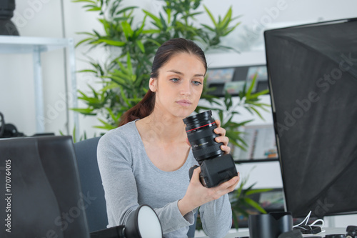 female photographer choosing camera for work