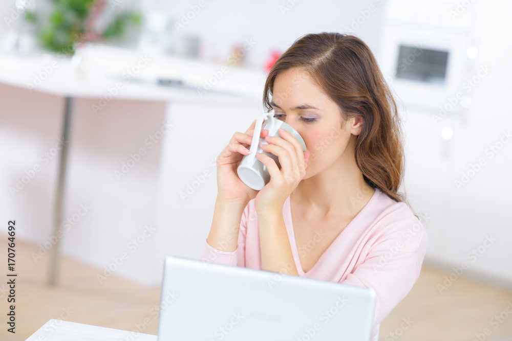 woman with tea and laptop woman with tea and laptop