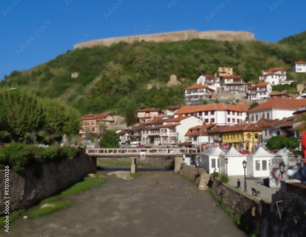 Blurred landscape of Prizren with the fortress on hilltop view from Lumbardhi River, Prizren, Kosovo