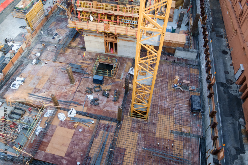 Crane rising through floor of highrise under construction
