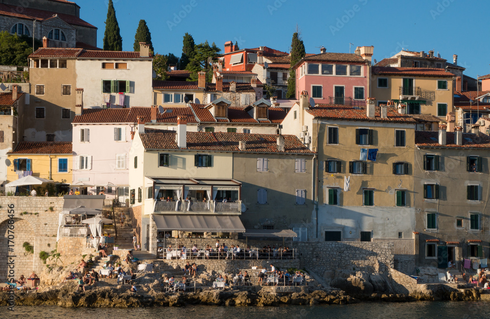 Rovinj, Croatia - July 22nd 2017: People enjoying dinner at a seaside restaurant