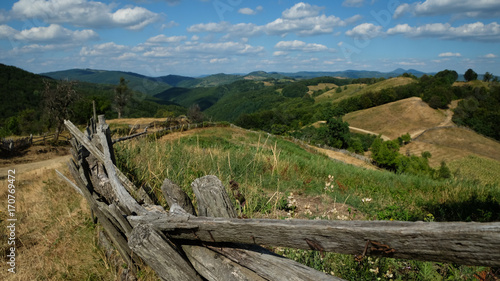 Fototapeta Naklejka Na Ścianę i Meble -  Landscape with old woody fence and hills in Romania