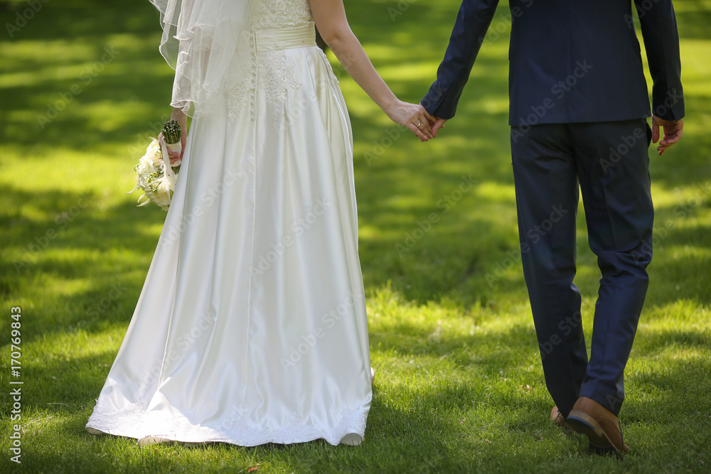 Bride and groom holding hands Bride and groom holding hands
