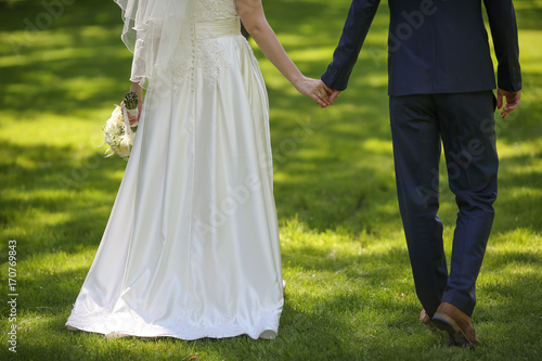 Bride and groom holding hands