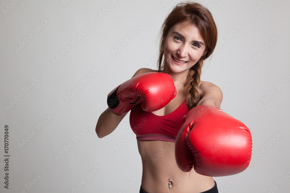 Beautiful healthy Asian girl with red boxing glove. Beautiful healthy Asian girl with red boxing glove.