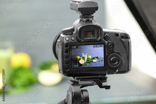 Photo of smoothie with ingredients on camera display in studio. Concept of food photography