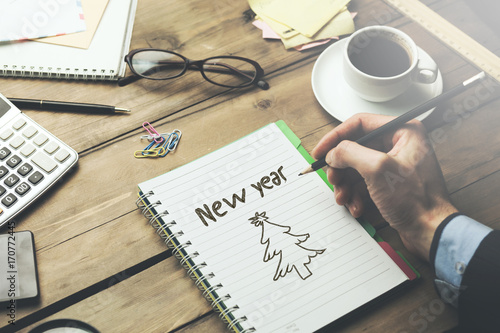 Females hands showing notepad against a new year