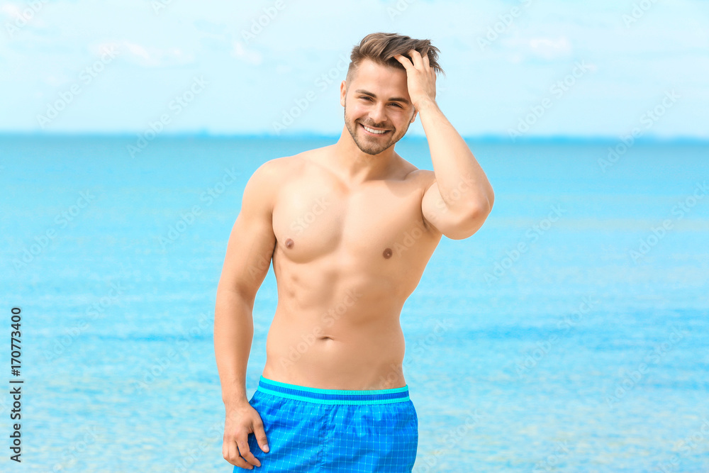 Handsome young man on sea beach