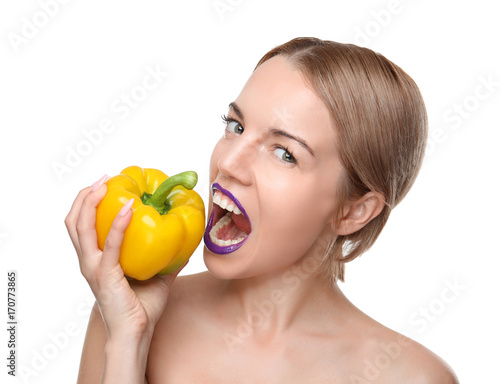 Young woman posing with yellow bell pepper isolated on white