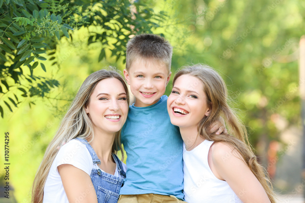 Lesbian mothers and foster son having fun outdoors Lesbian mothers and foster son having fun outdoors
