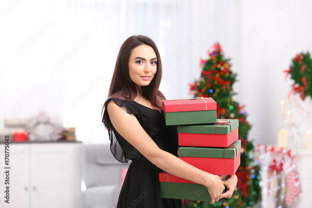 Attractive young lady with gift boxes at home Attractive young lady with gift boxes at home