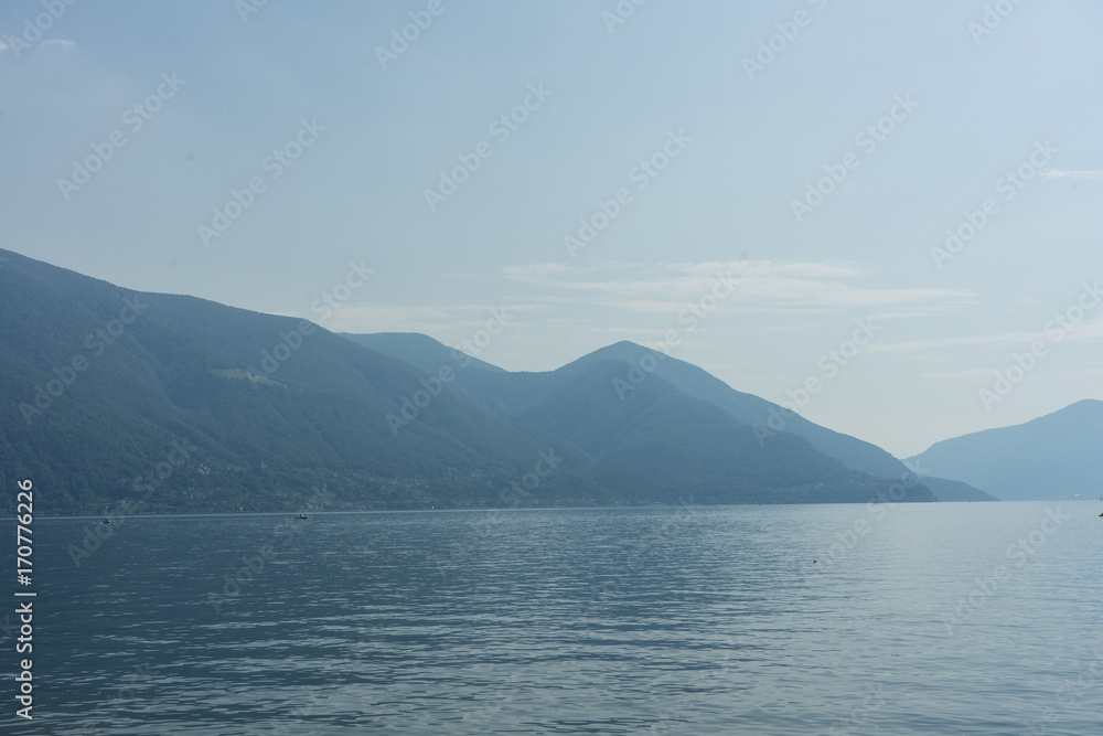Lago Maggiore Lake with fog and Mountain landscape in Ascona Switzerland