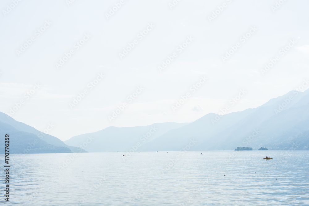Boats on lago maggiore lake in ascona switzerland with mountain view landscape and water