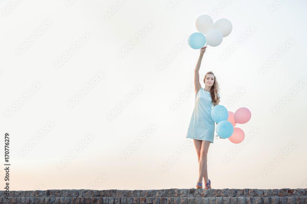 beautiful woman with flying multicolored balloons beautiful woman with flying multicolored balloons