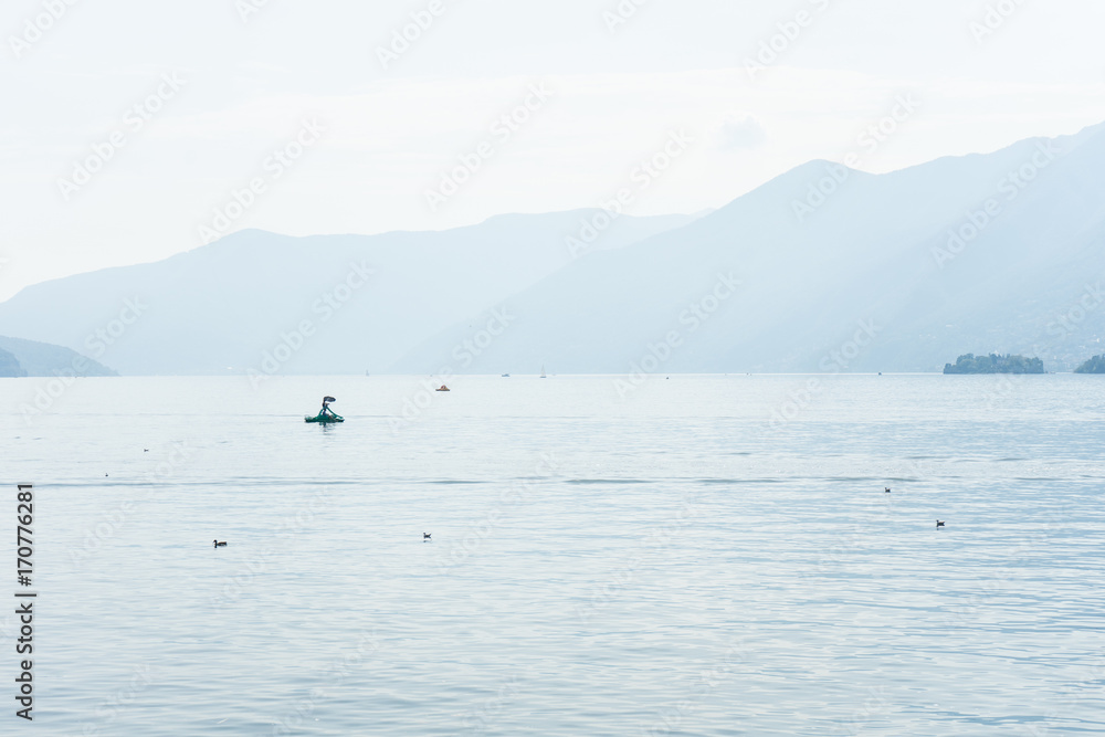 Boats on lago maggiore lake in ascona switzerland with mountain view landscape and water Boats on lago maggiore lake in ascona switzerland with mountain view landscape and water