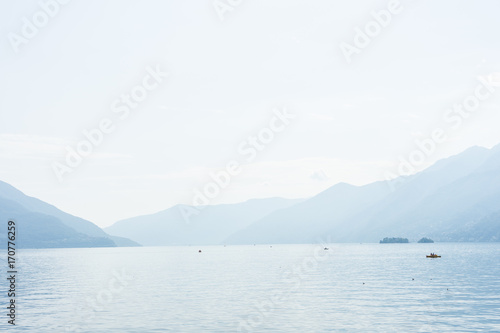 Boats on lago maggiore lake in ascona switzerland with mountain view landscape and water © DSGNSR