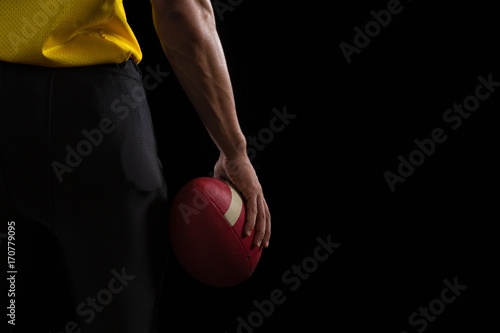 American football player holding a ball  © WavebreakMediaMicro