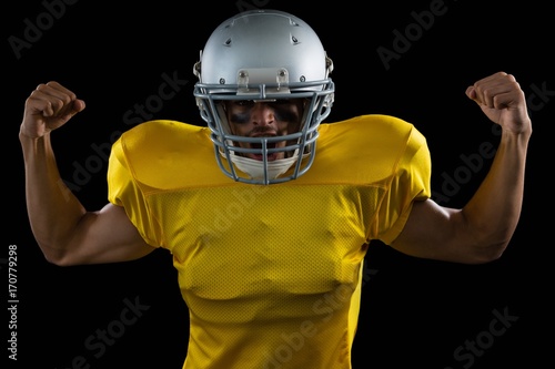 American football player flexing his muscles © WavebreakMediaMicro