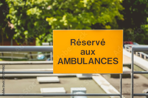 yellow sign or it is written in French: reserved for ambulances