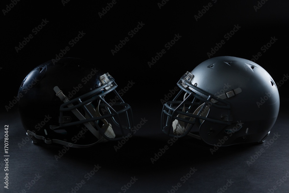 Fototapeta premium American football head gear facing each other
