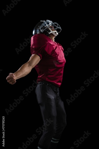 American football player posing with arms stretched open © WavebreakMediaMicro